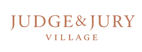 Judges and jury members sitting outdoors at Judge & Jury Village, an event space for legal-themed gatherings and community events in New Zealand.